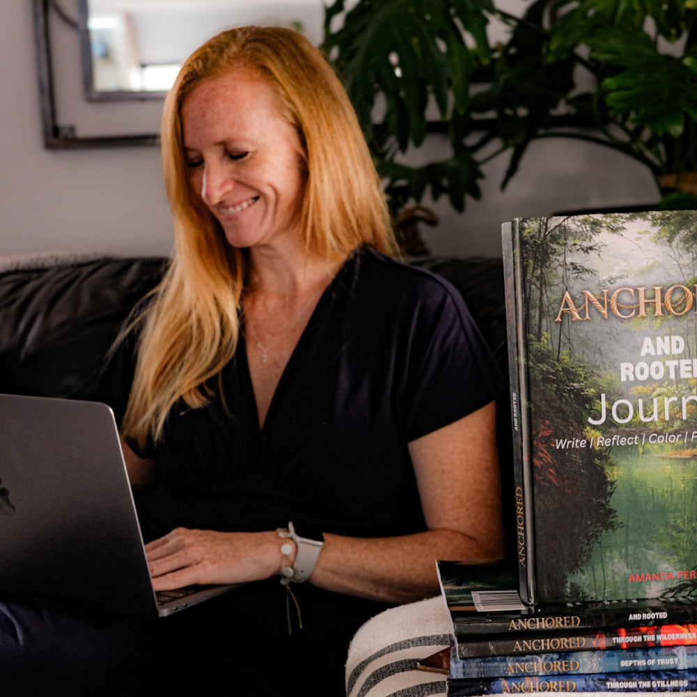 Amanda with Anchored Journal Series Hardcover in her lounge at home