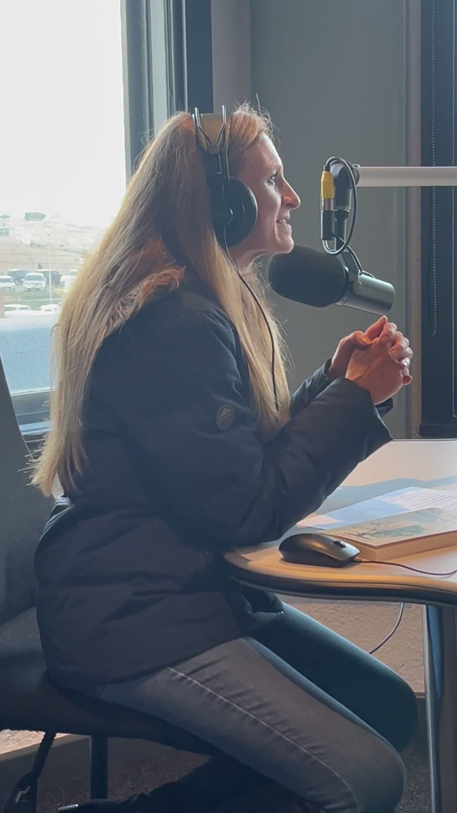 Amanda Perry speaking at the microphone in the CCFM studio during The Harvest Table