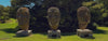 Amanda Perry Walking Slowly passed some face statues